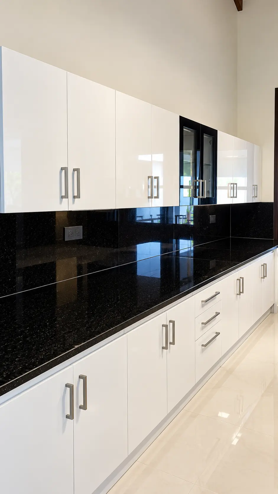 Bright white pantry with a long dark granite counter — design concept